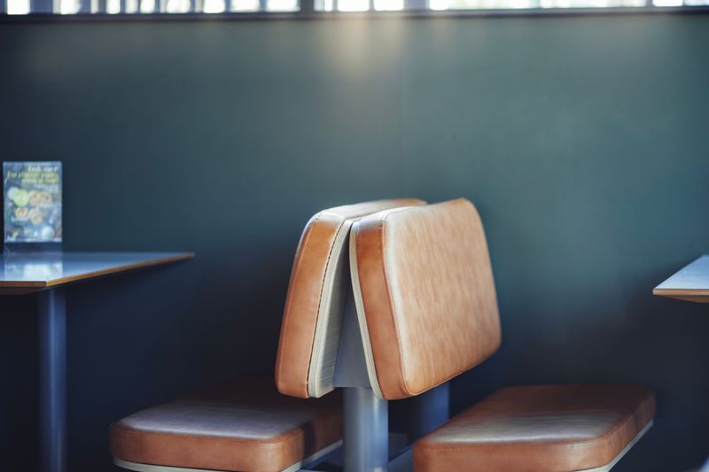 Cozy corner booth seating in Pizza inn restaurant interior